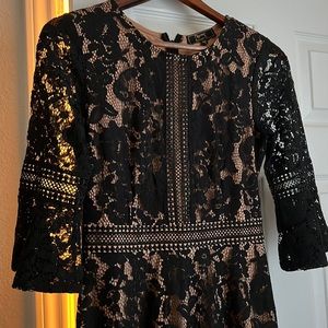 Lovely lace dress. Doesn’t show much skin, but gives you some mystery